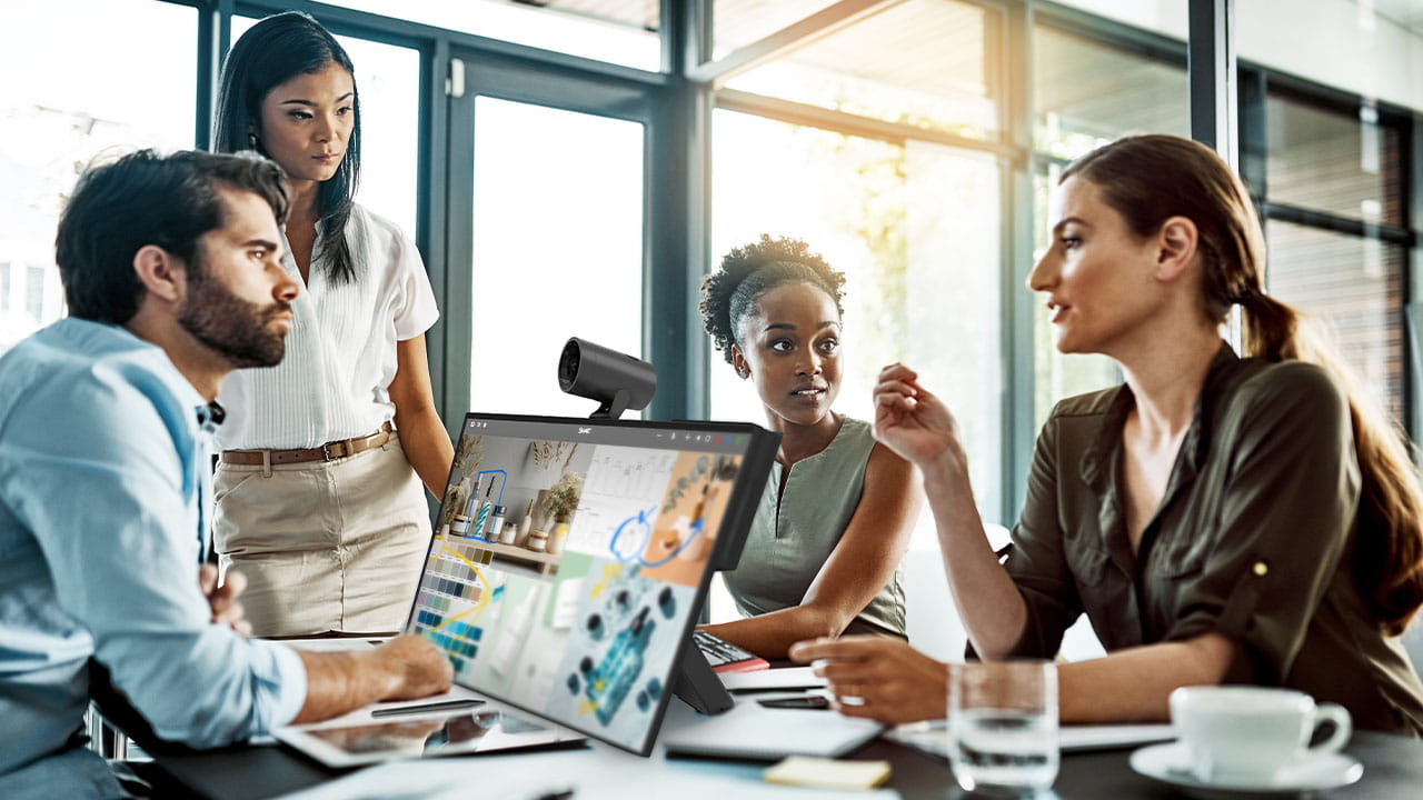 A collaborative office meeting featuring a SMART Board Mini Interactive Podium, with a diverse team engaged in discussion.