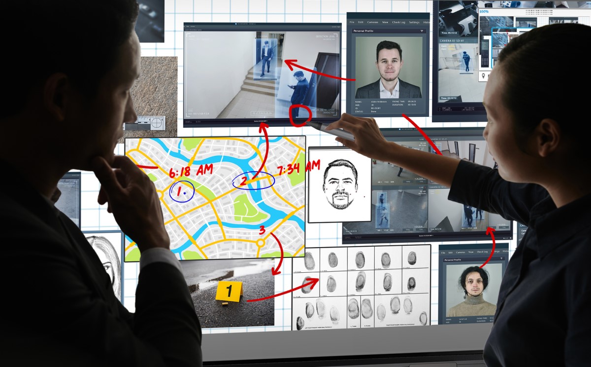 Security professionals analyze surveillance footage and maps on a SMART interactive display in a high-tech monitoring center.