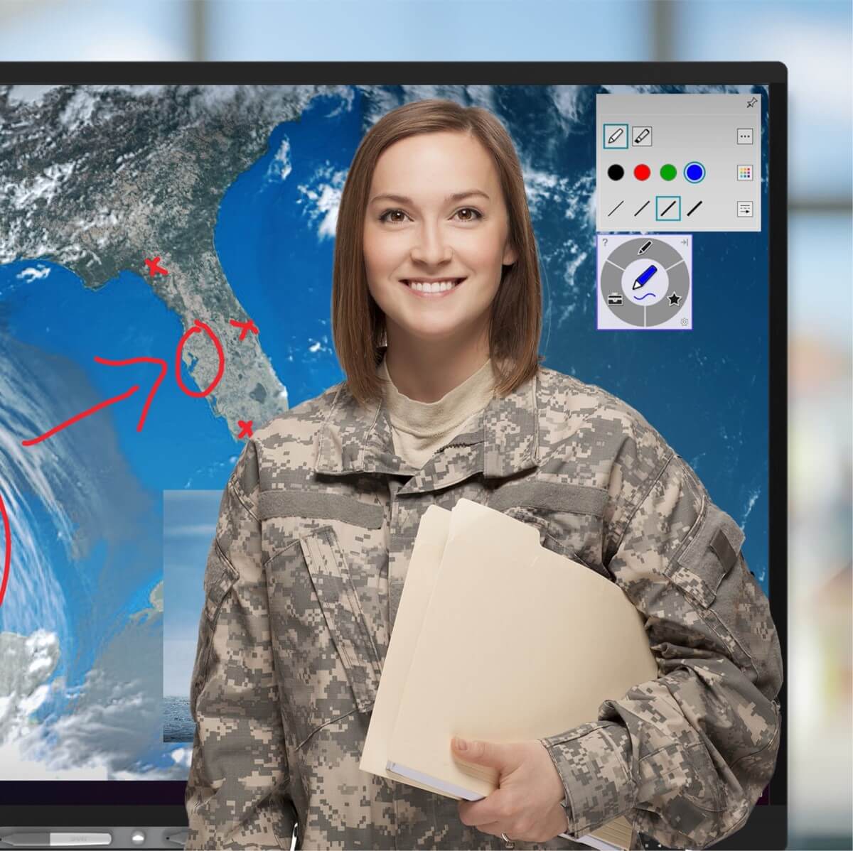A smiling woman in military uniform standing in front of a SMART interactive display.