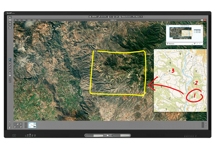 An interactive display screen showing a satellite image of a rugged terrain with marked areas for tactical planning, part of the SMART Meeting Pro suite which offers tools for digital brainstorming and collaboration.