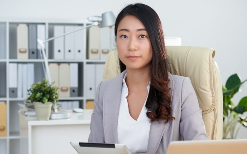 Professional Lumio admin seated at her desk, focusing on work in a modern office.